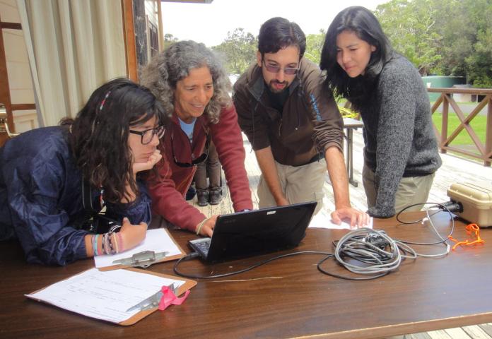 USGS Center Director and employees looking at a computer