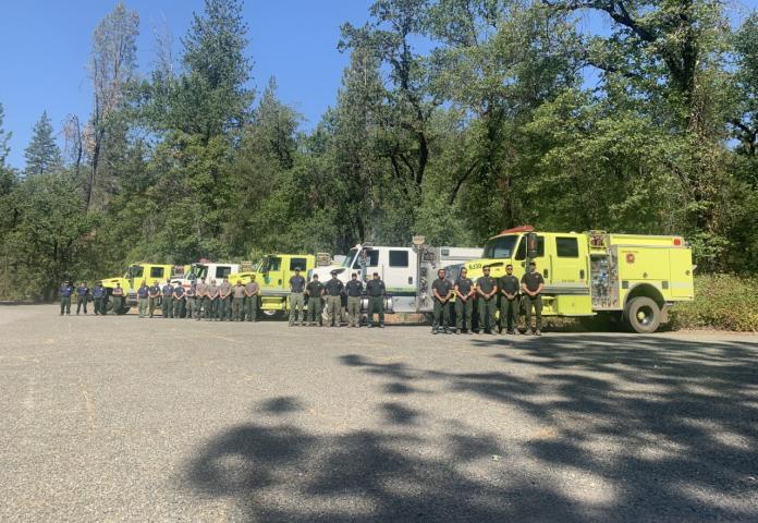 Wildland Firefighter crews assembled in front of engines