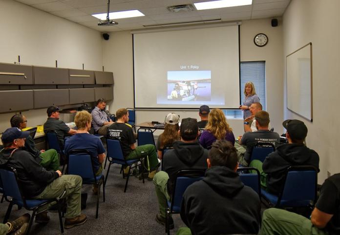 Group of individuals being instructed in a classroom