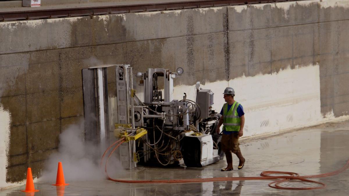 BSEE technician performing maintenance work on 2.6 million gallon outdoor concrete tank that included sandblasting, painting and other repair and replacement work.