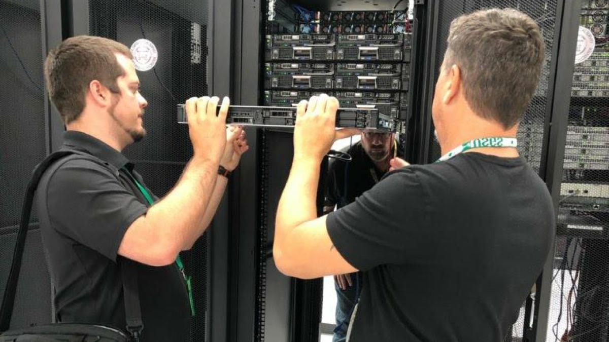 Two men installing a server