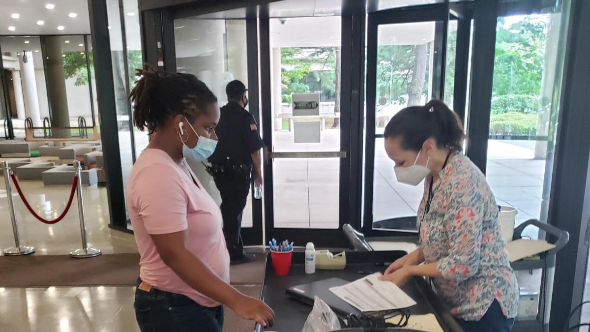 Two employees reviewing computer equipment