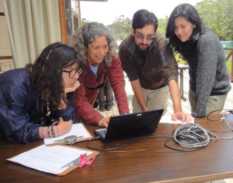 USGS Center Director and employees looking at a computer