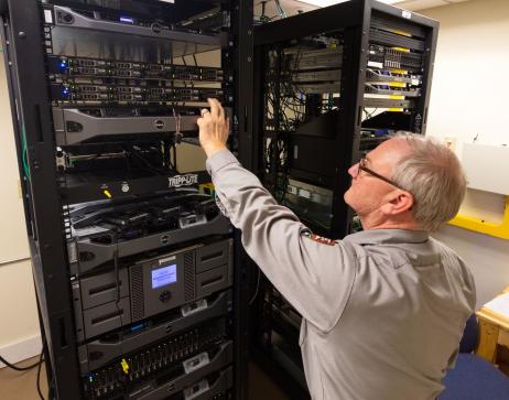 Man in tan shirt working on a server rack