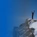 Person standing on top of a mountain