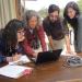 USGS Center Director and employees looking at a computer