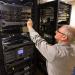 Man in tan shirt working on a server rack