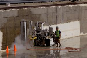 BSEE technician performing maintenance work on 2.6 million gallon outdoor concrete tank that included sandblasting, painting and other repair and replacement work.
