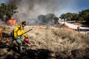 Firefighter performing prescribed fires