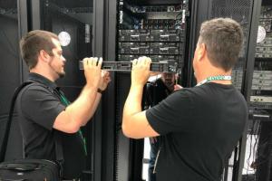 Two men installing a server