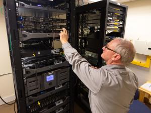 Man in tan shirt working on a server rack